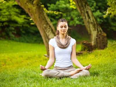 Young female meditate in nature