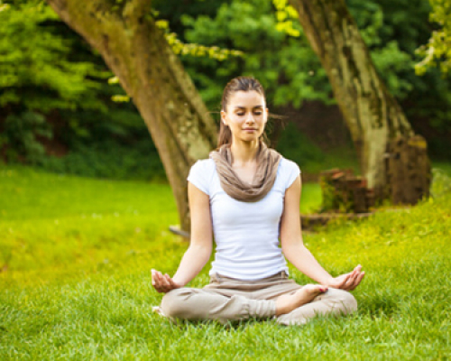 Young female meditate in nature